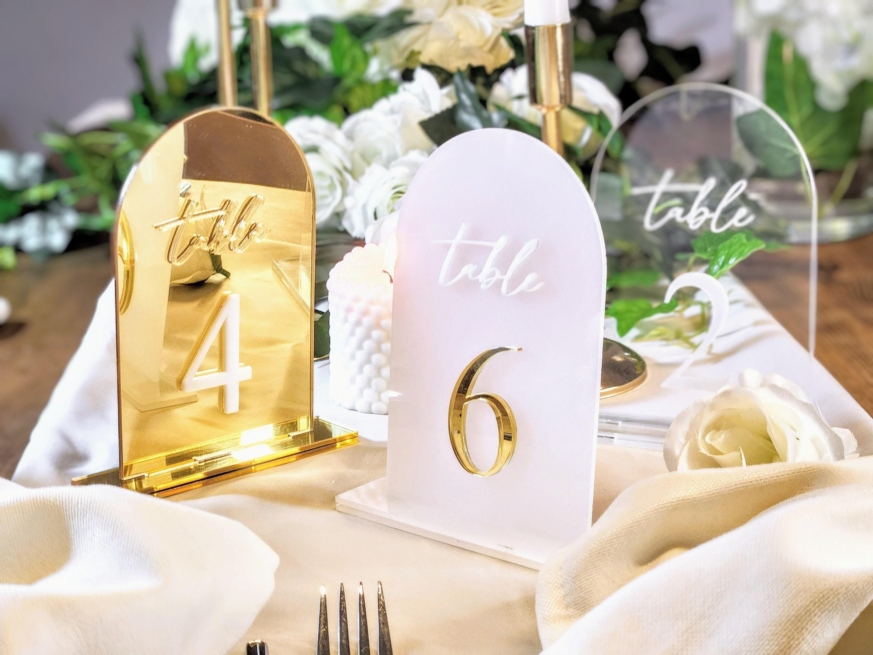 Acrylic wedding table numbers in gold mirror finish styled on reception tables for wedding and engagement decor