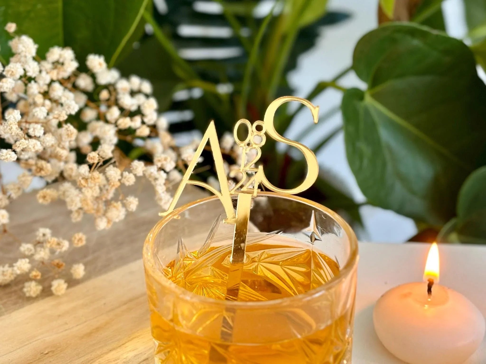 Custom acrylic drink stirrers in gold mirror finish styled with signature cocktails at a wedding bar