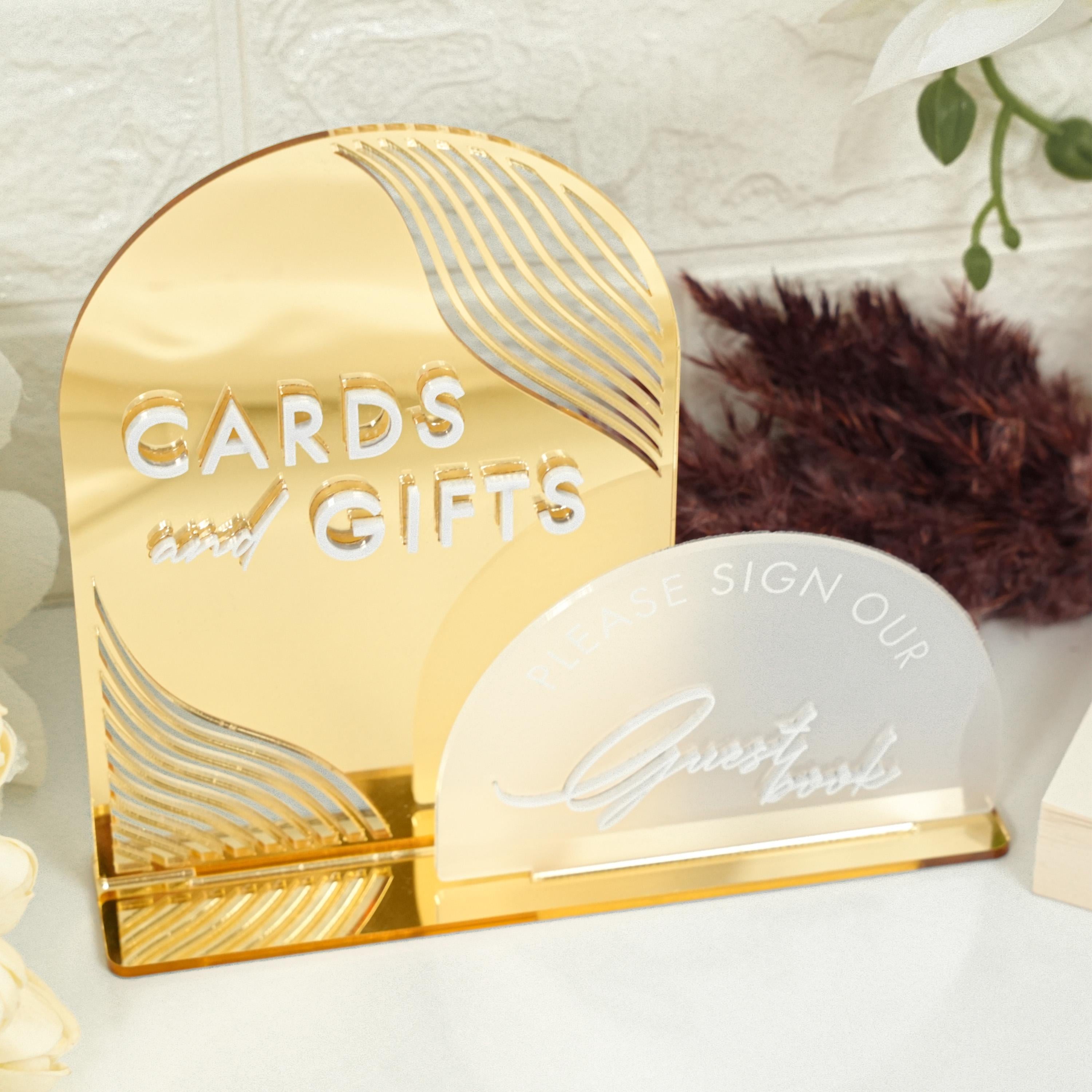 a couple of gold cards and a sign on a table