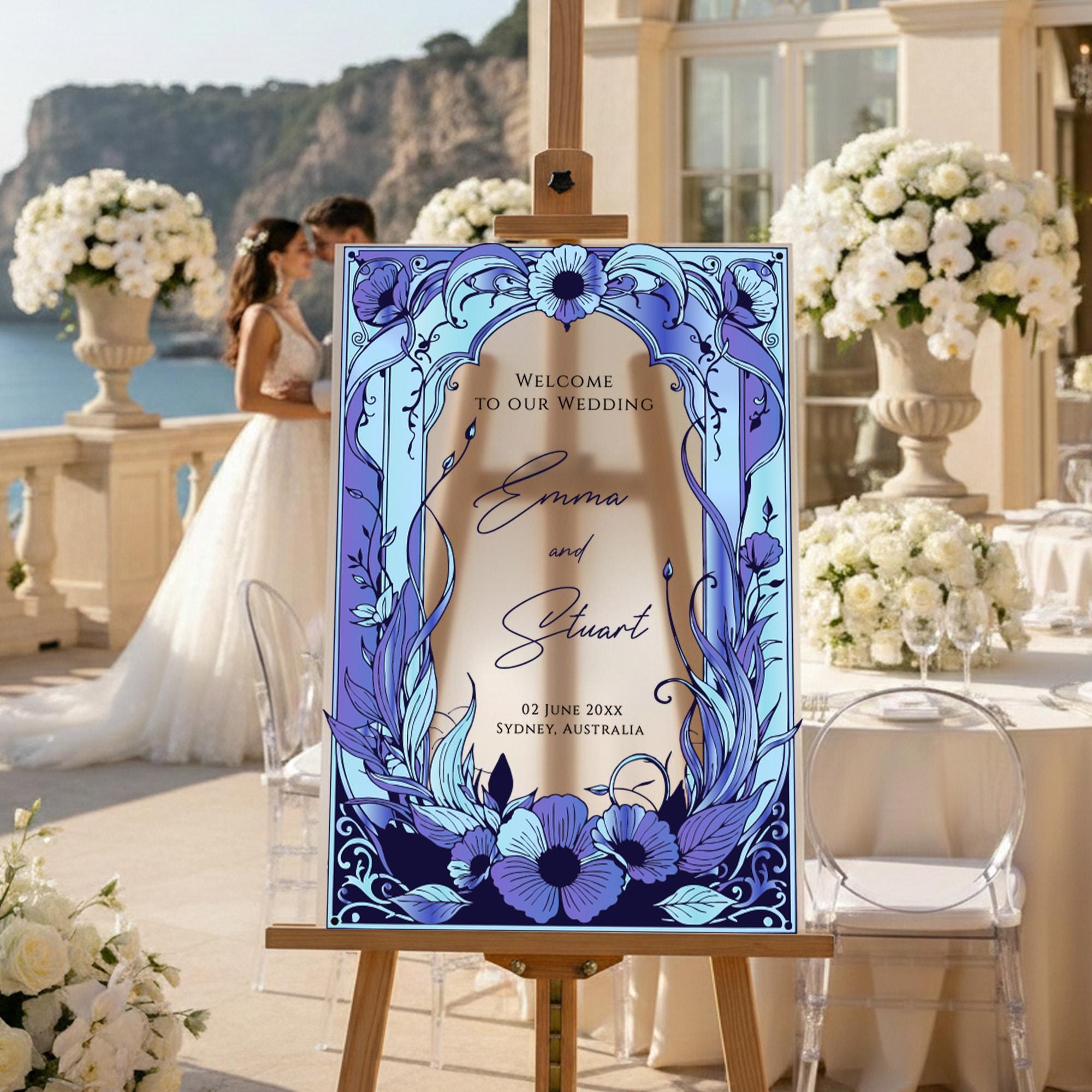 a wedding invitation with a bride and groom standing in the background, surrounded by elegant floral arrangements and a scenic view.