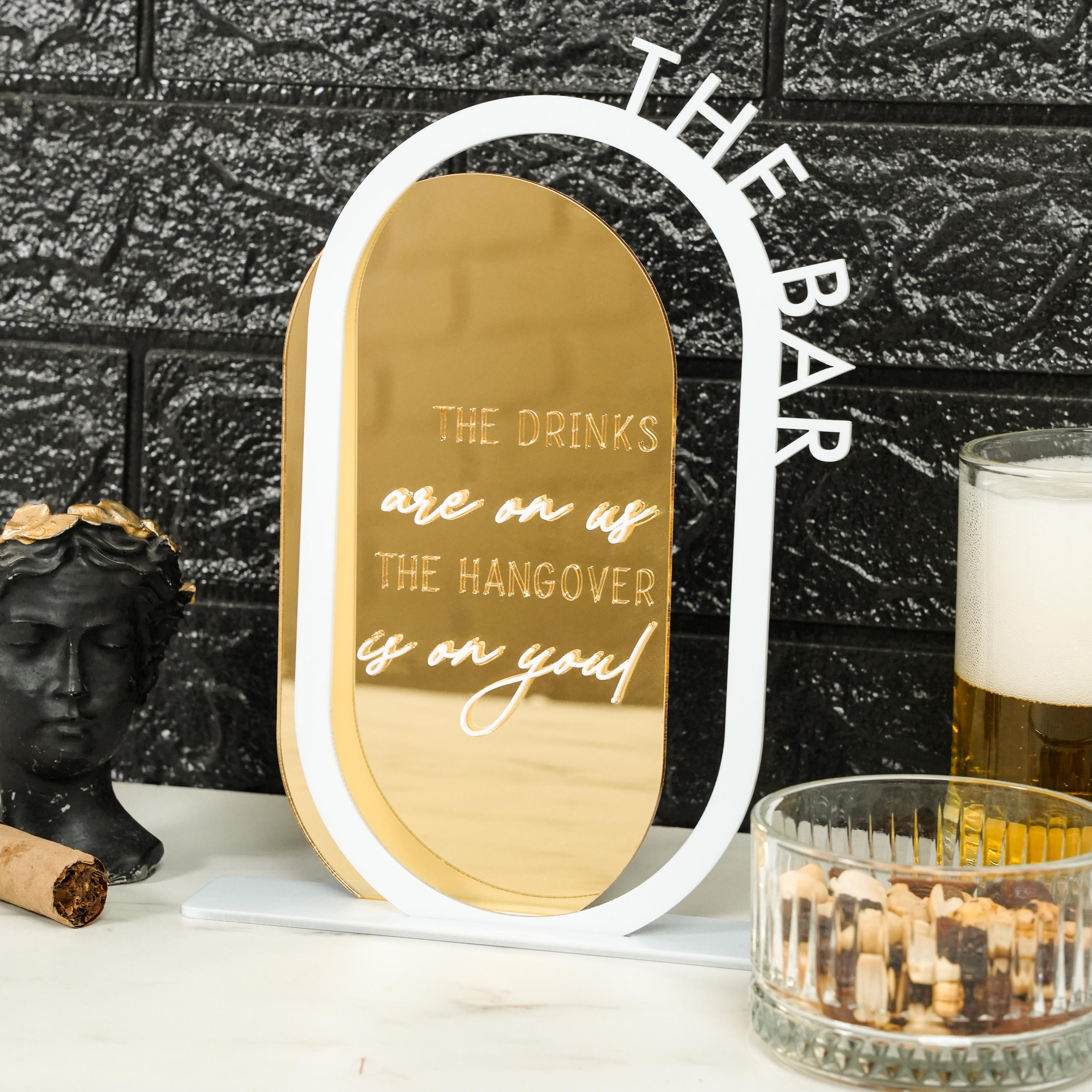 a glass of beer next to a mirror and a candle