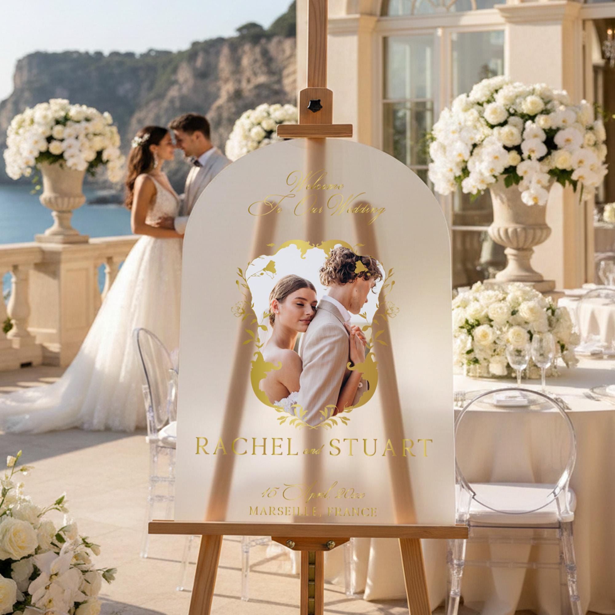 a wedding invitation featuring a couple embracing in a romantic setting, with a scenic backdrop of a cliff and ocean.