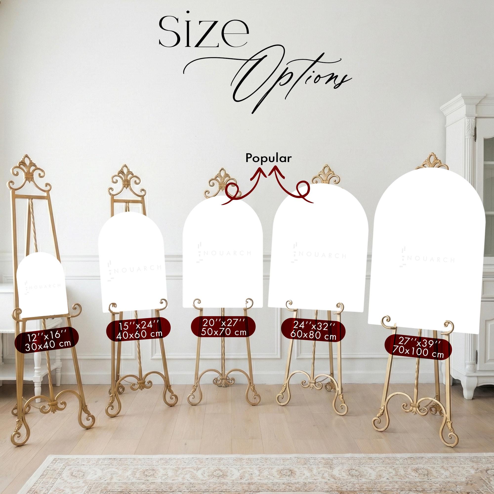 a collection of five different sizes of white arch-shaped boards or easels, each with a gold frame, arranged in a row against a white wall.