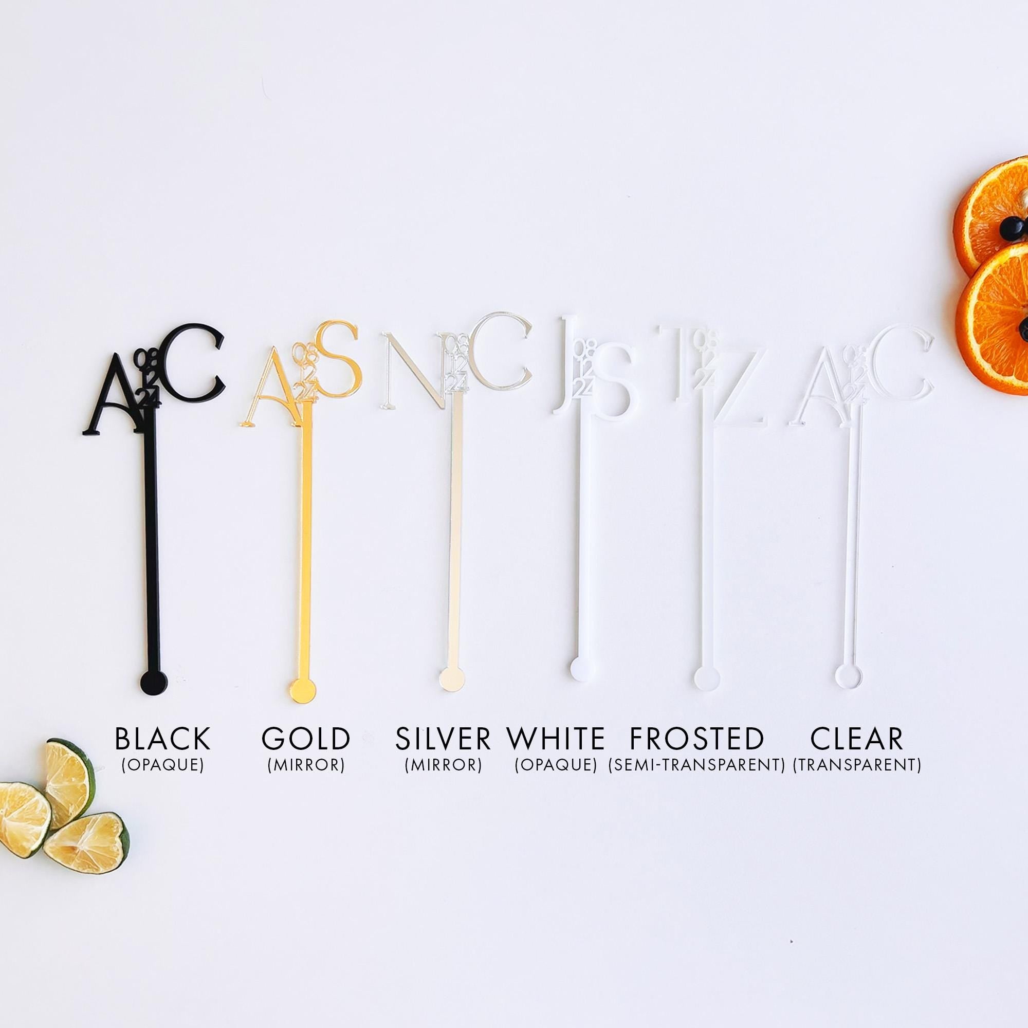 a white table topped with orange slices and black and white utensils