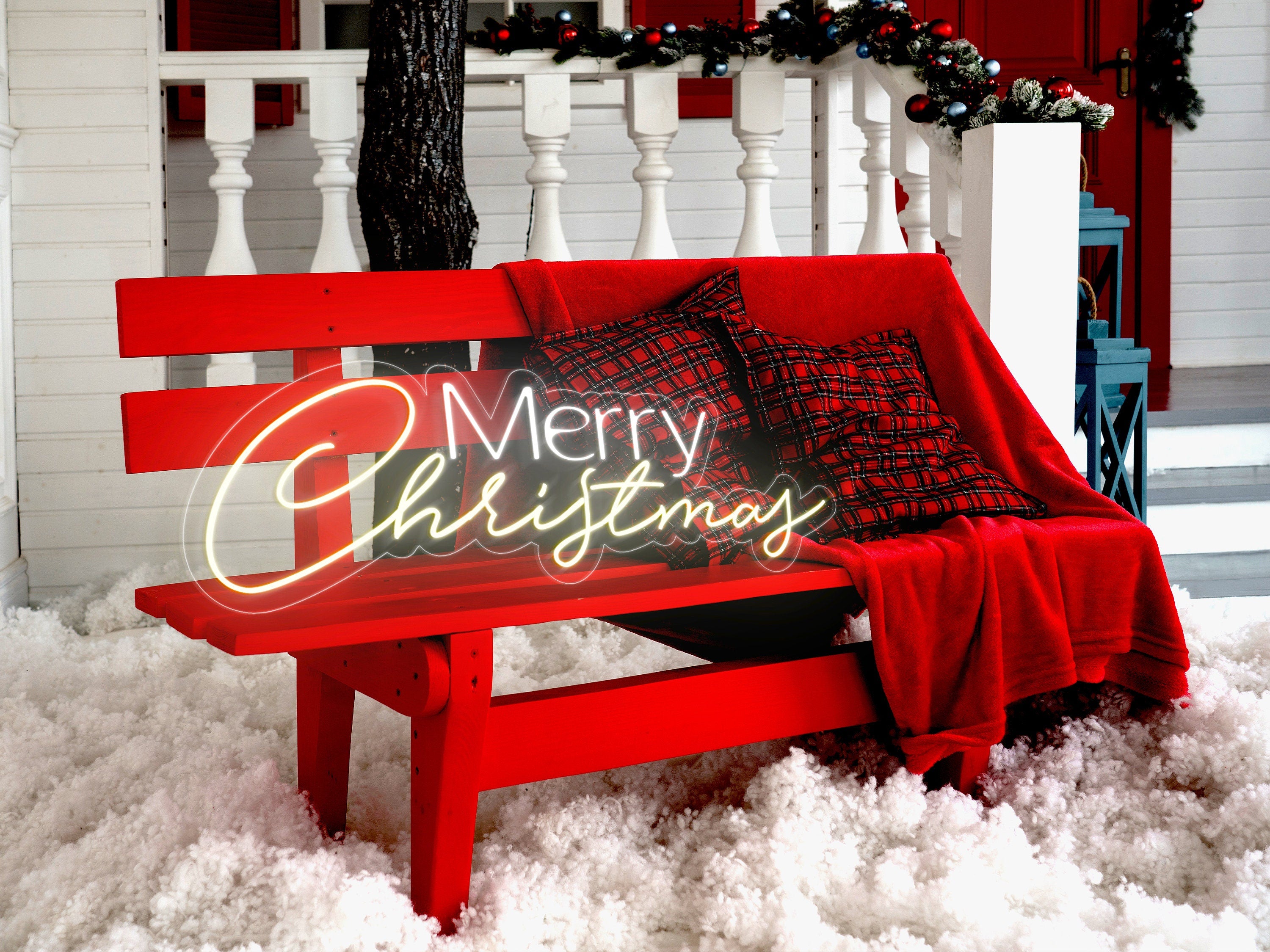 a red bench with a merry christmas sign on it