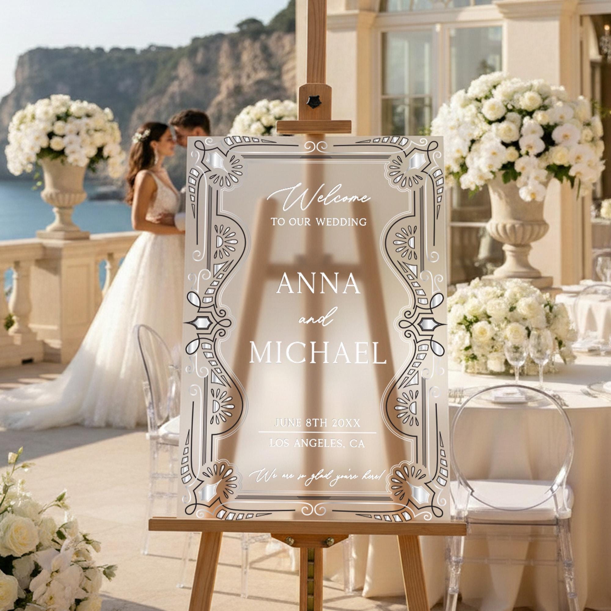 a wedding invitation with a couple standing in the background, surrounded by elegant floral arrangements and a scenic view.