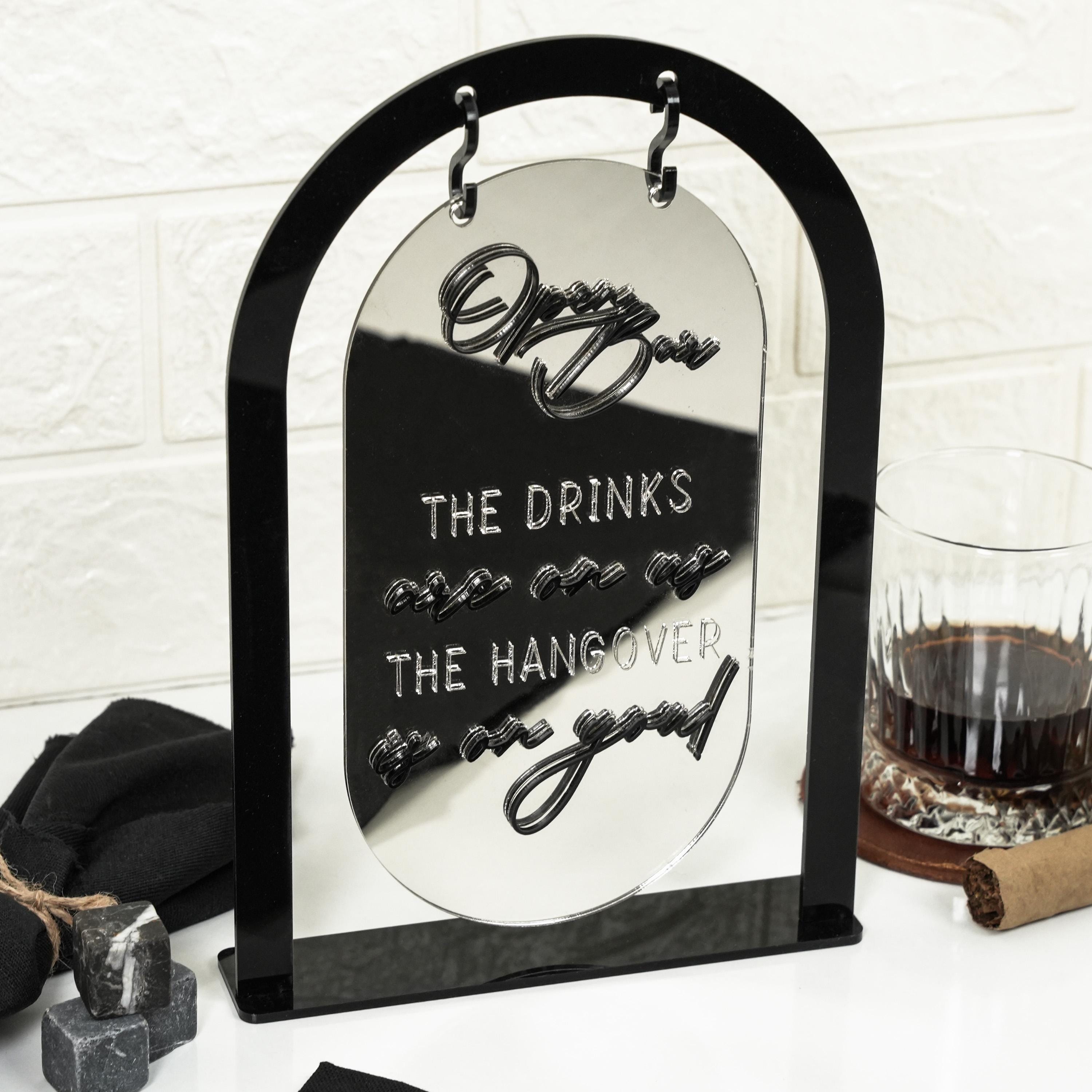 a picture frame with the words the drinks the hangover and a glass of wine