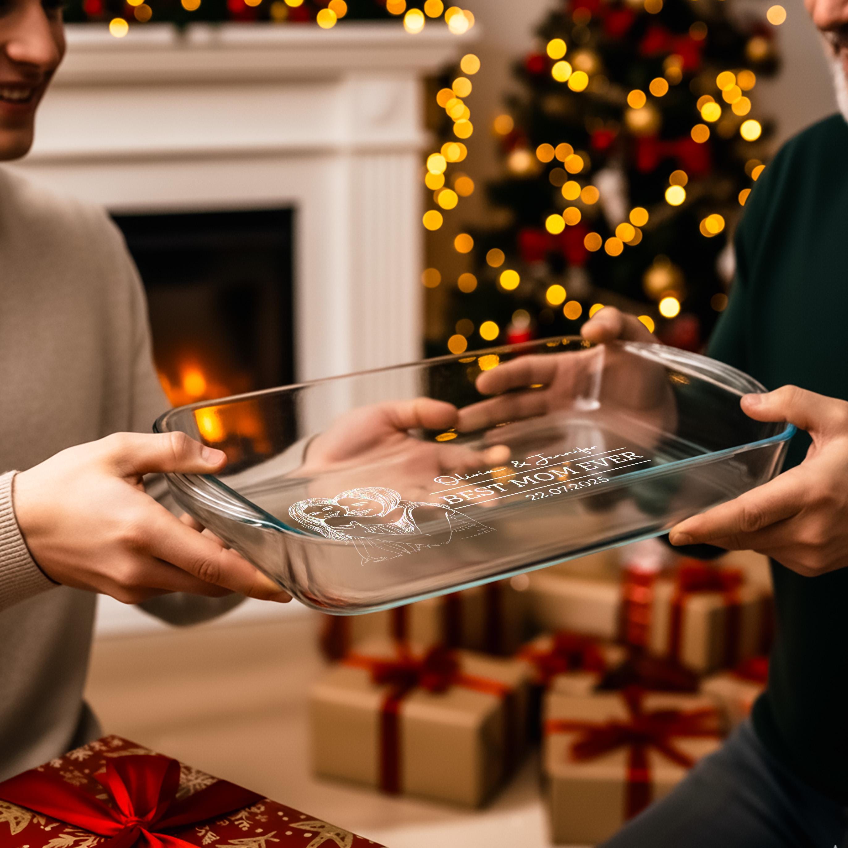 A person is holding a clear glass dish with a message written on it, while another person is smiling and holding a gift box with a red ribbon. The background features a Christmas tree with twinkling lights.