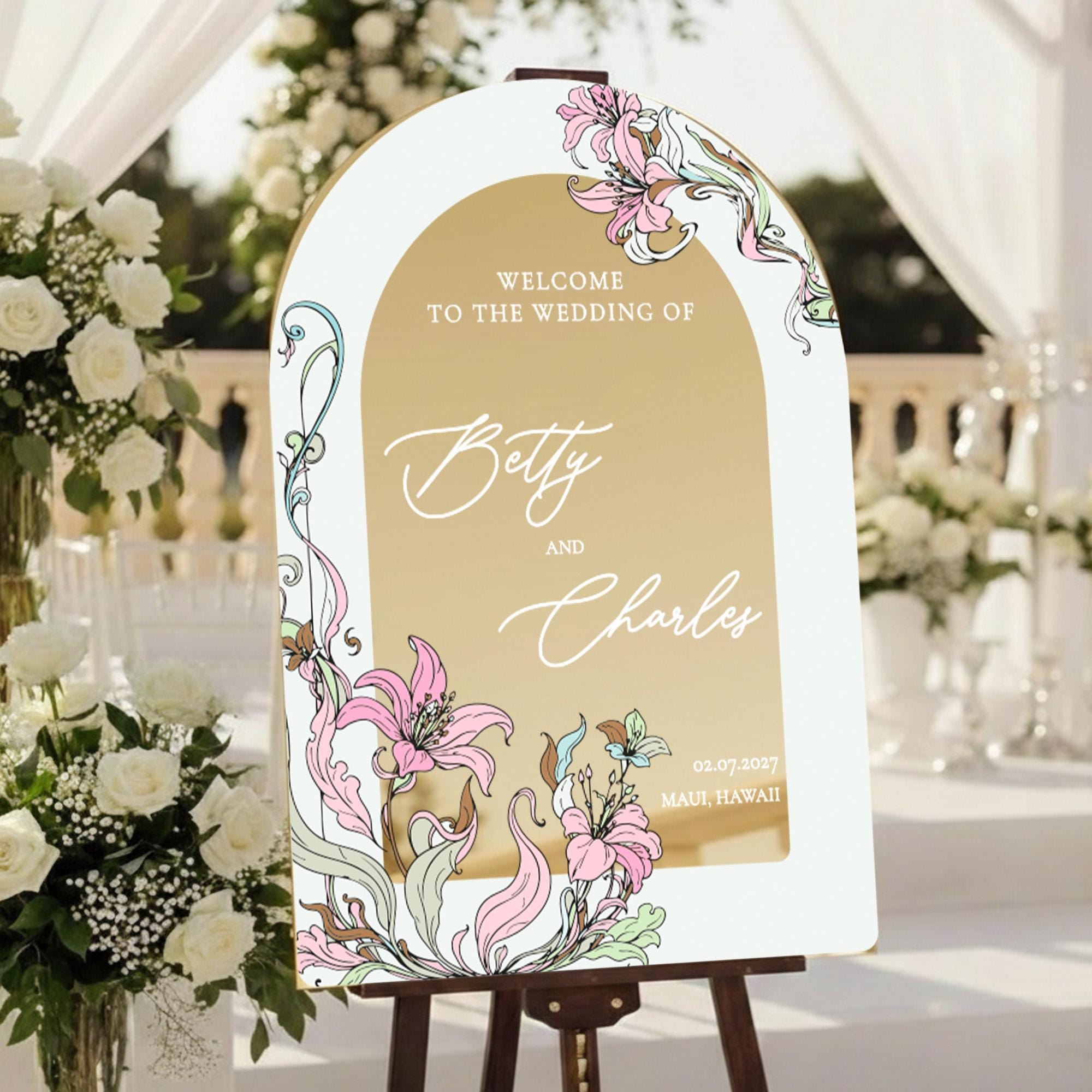 a wedding invitation sign with a floral design and text welcoming guests to the wedding of Betty and Charles.