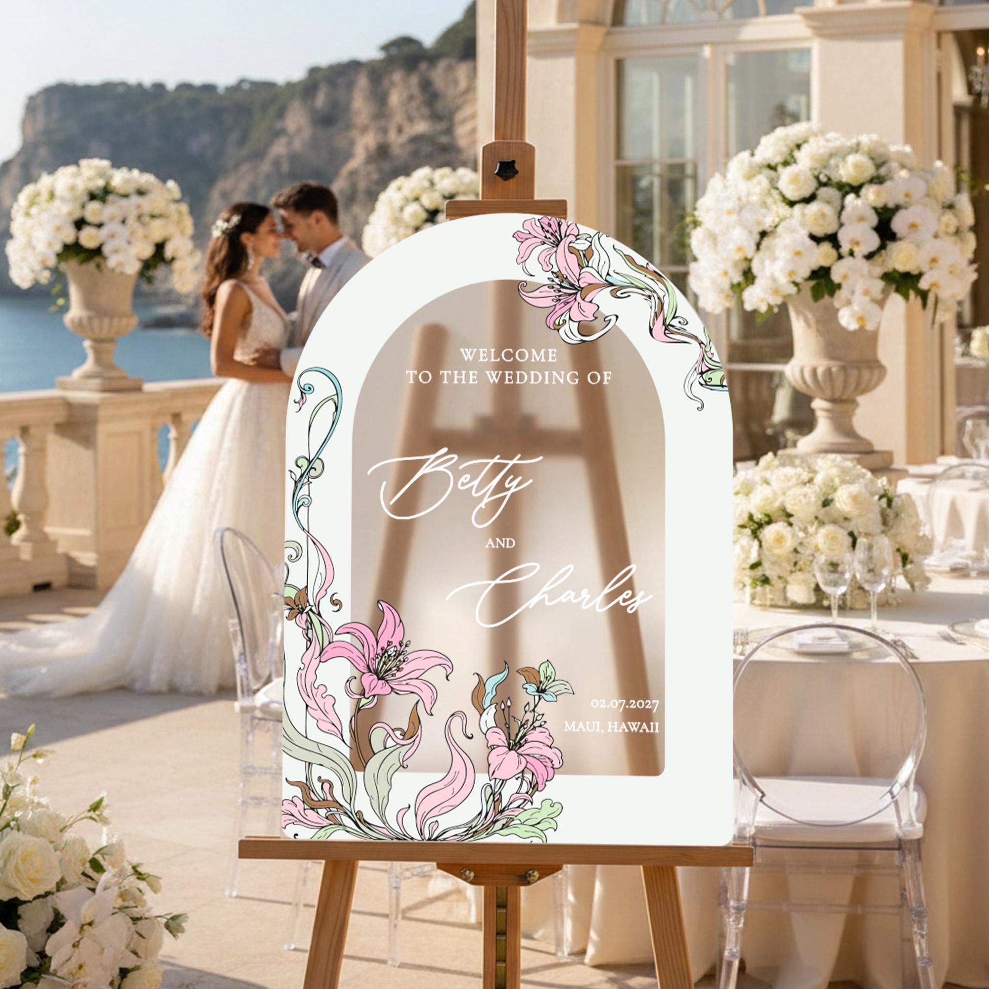 a wedding invitation with a couple standing in the background, surrounded by a beautiful floral arrangement and a scenic view.
