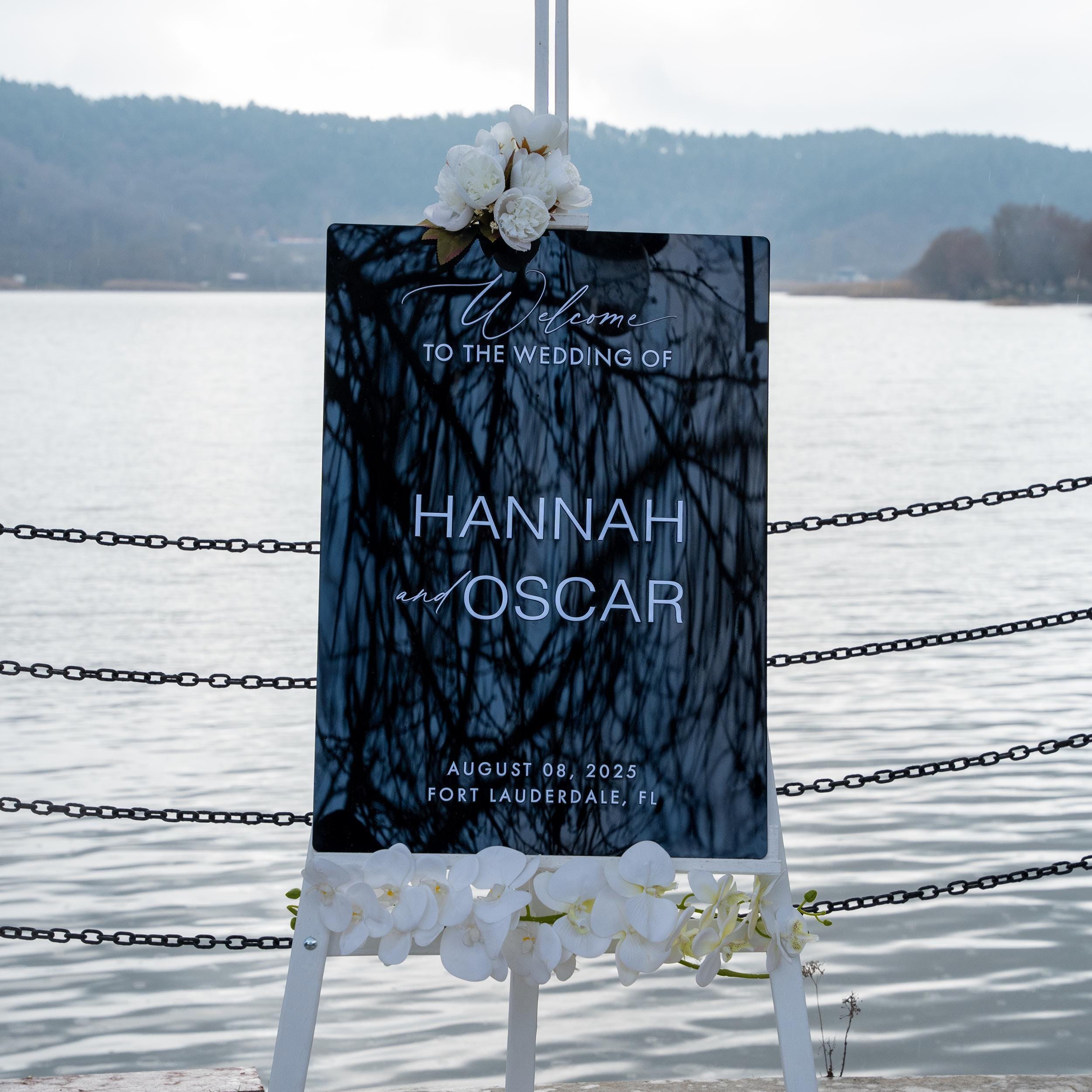 modern black acrylic wedding welcome sign with 3D lettering, featuring the couple's names and wedding details. The sleek and modern design adds a timeless and stylish touch to any wedding entrance.