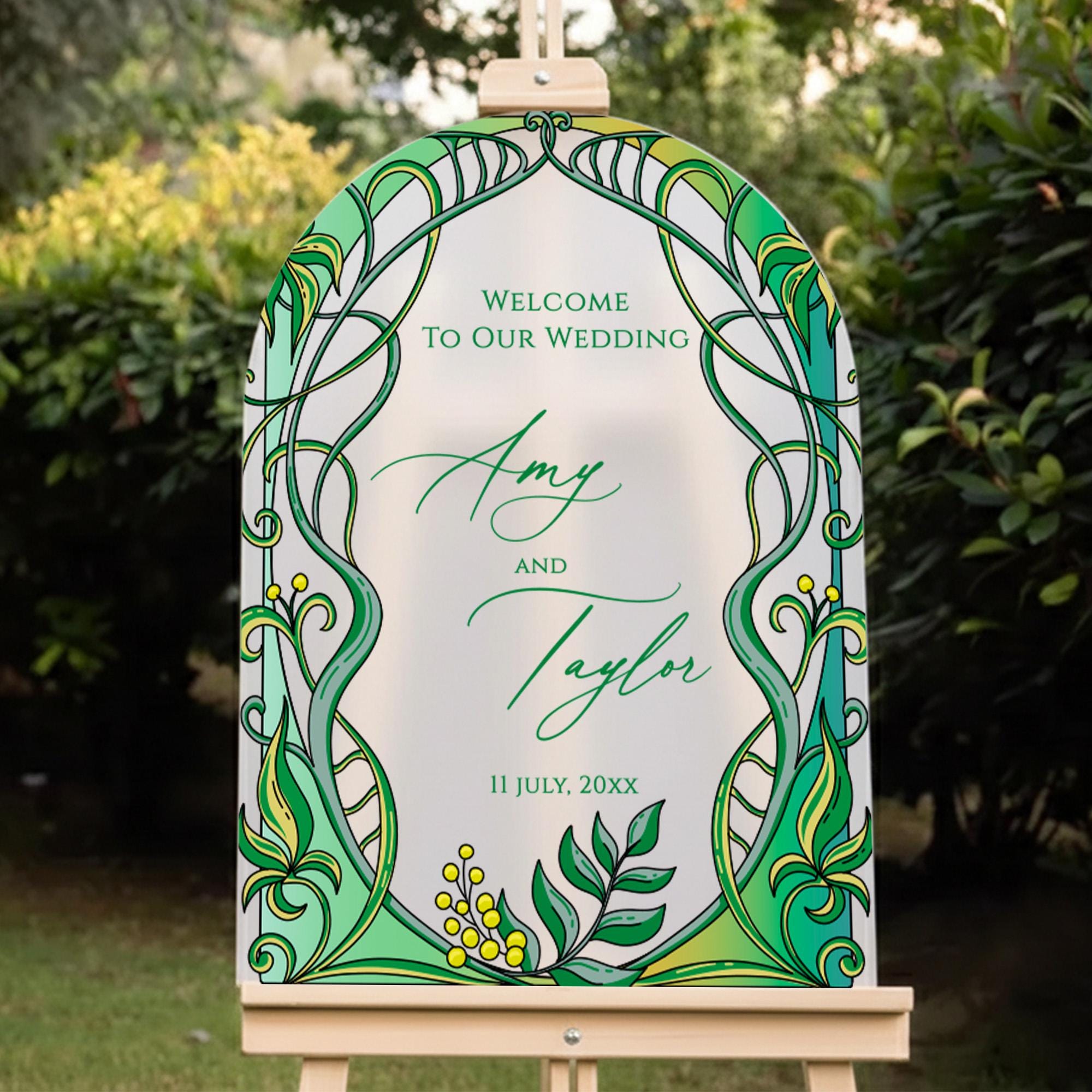 a wedding invitation sign with a green and yellow design, displaying the names "Amanda and Taylor" and the date "11 July, 20xx".