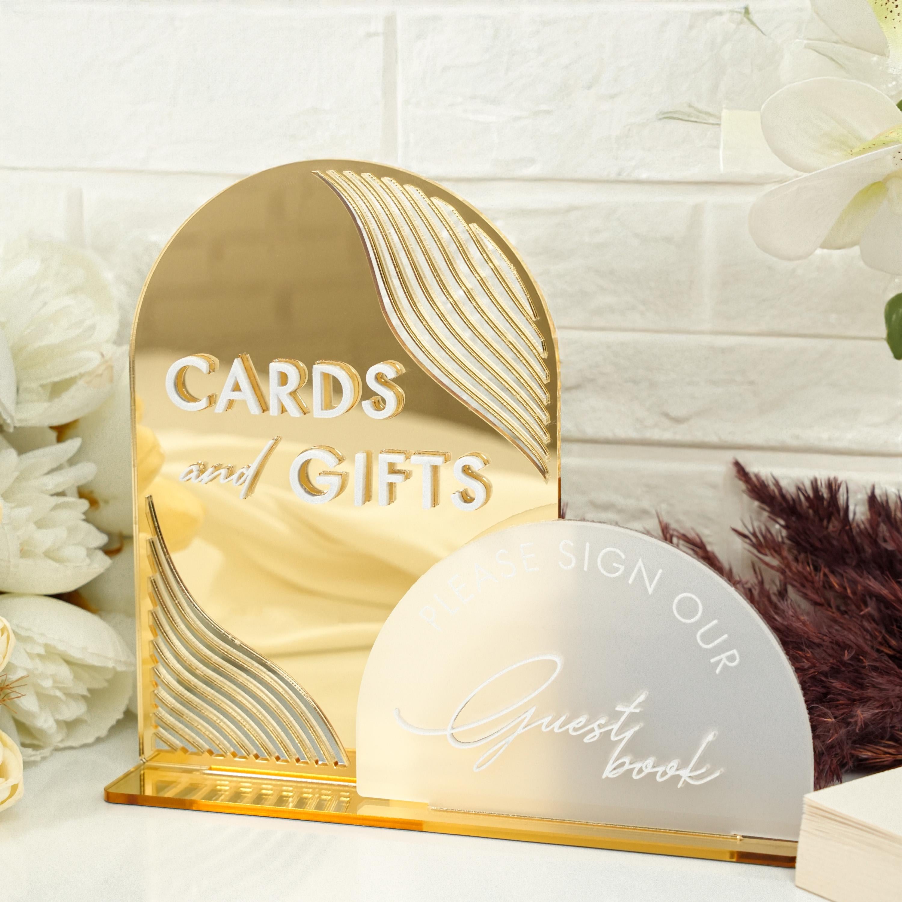 a white flower and a gold card and gift box