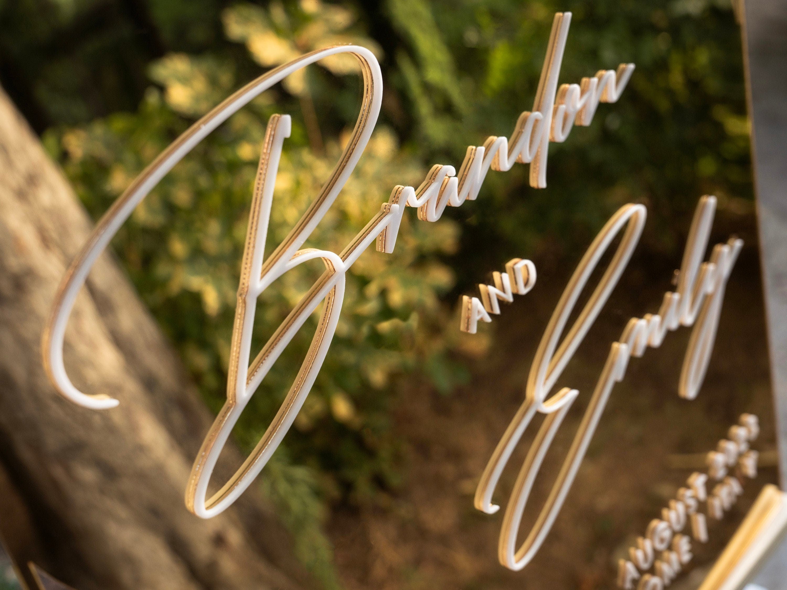 Close-up detail of a gold mirror acrylic wedding welcome sign with raised 3D white lettering, Rome Collection design