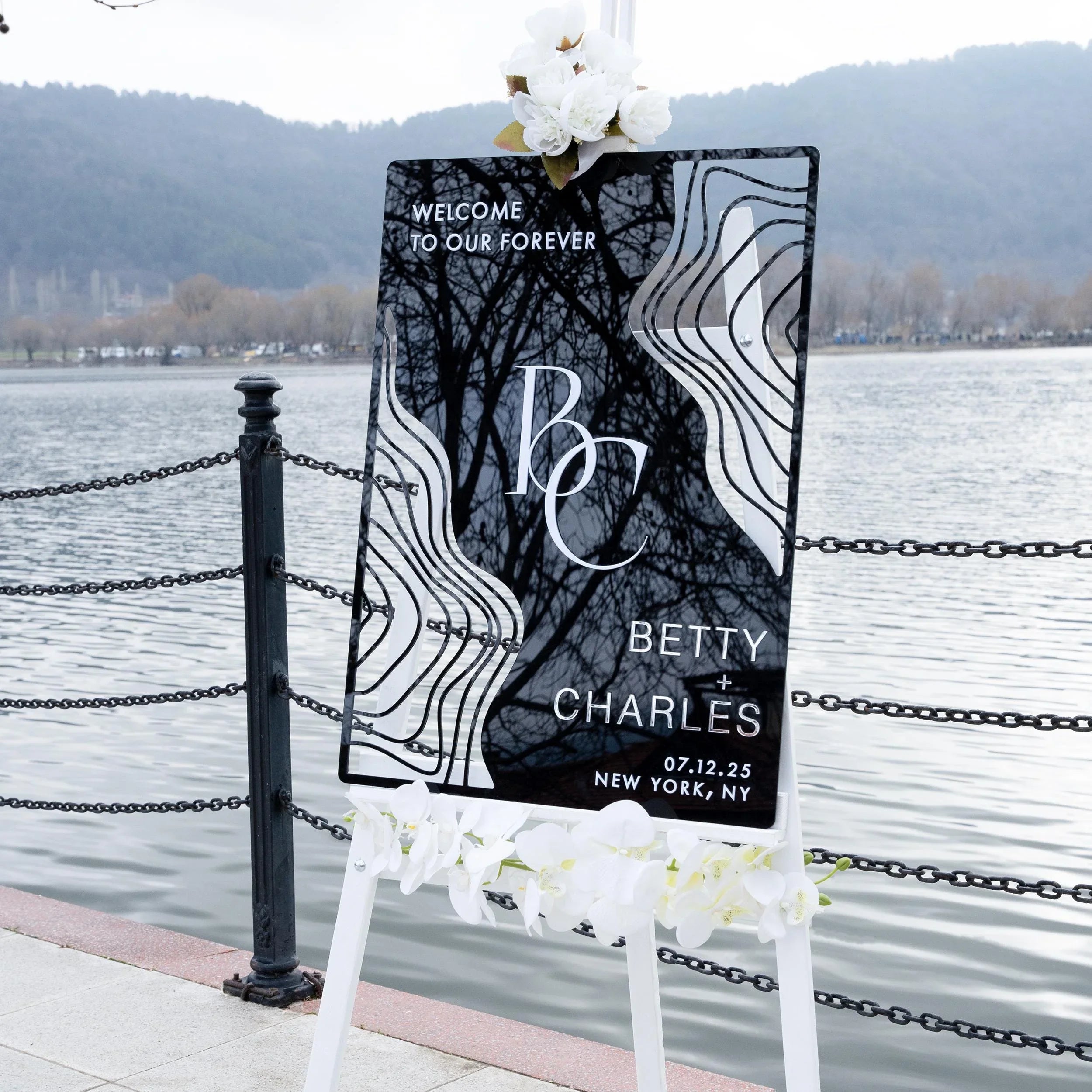 Boho black acrylic wedding welcome sign with striking 3D lettering, featuring the couple’s initials, names, and wedding date. The sleek design and artistic wavy accents create a stylish, contemporary focal point at any wedding entrance.