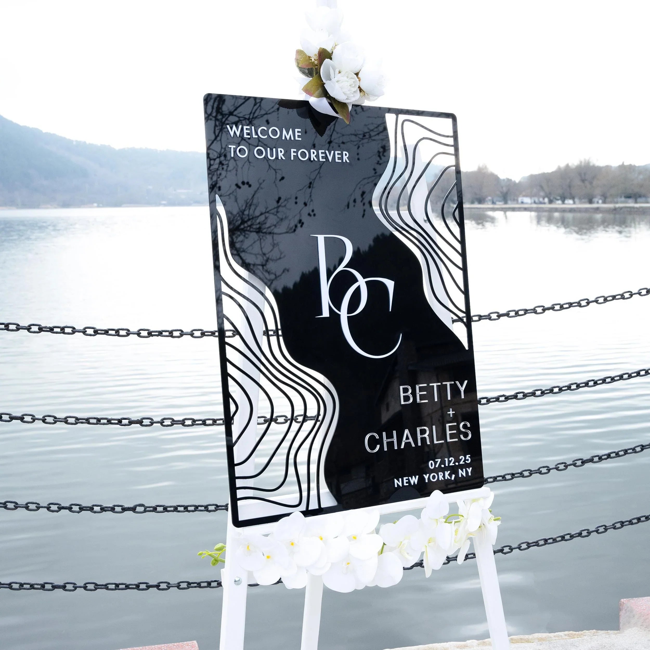 Boho black acrylic wedding welcome sign with striking 3D lettering, featuring the couple’s initials, names, and wedding date. The sleek design and artistic wavy accents create a stylish, contemporary focal point at any wedding entrance.